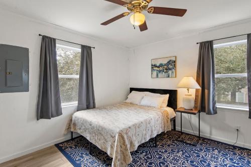 a bedroom with a bed and a ceiling fan at The Flying Dutchman OBX in Kill Devil Hills