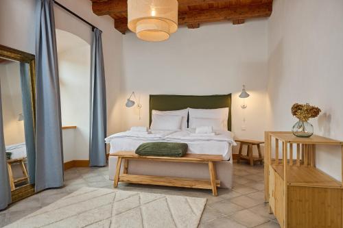 a bedroom with a bed and a table in it at TR 1823 Vendégház in Mád