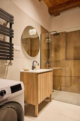 a bathroom with a sink and a mirror and a shower at TR 1823 Vendégház in Mád