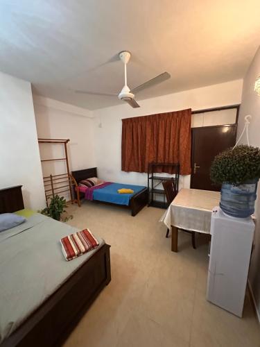 a living room with two beds and a couch at hostel of sincerity Female only in Maharagama