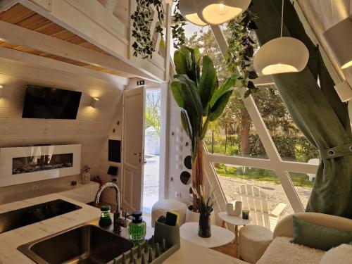 a kitchen with a sink and a large window at White DIAMOND in Chalkidiki in Vergia