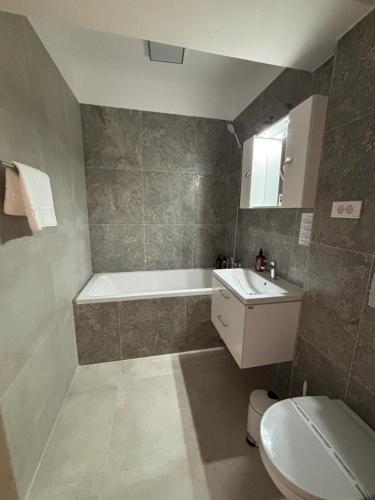 a bathroom with a tub and a sink and a toilet at The Urban Hide by D'or Selection in Bucharest