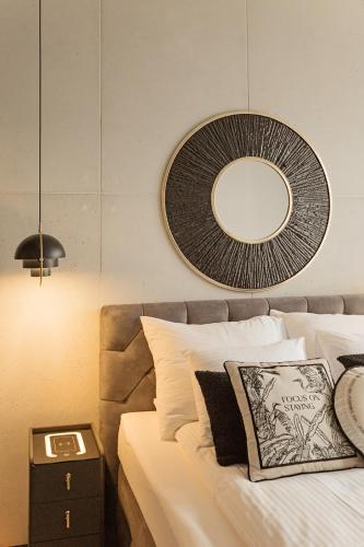a bedroom with a bed with a mirror on the wall at Apartament Husarski - City Park in Poznań