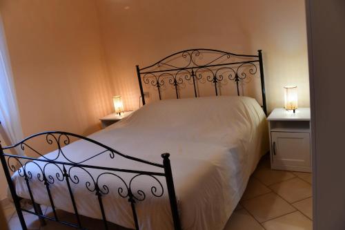 a bedroom with a white bed with two night stands at Casa Broglia in Castel Santa Maria