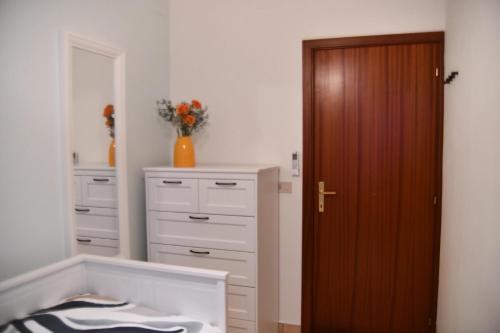 a room with a closet and a dresser and a door at Casa Broglia in Castel Santa Maria