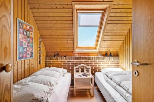 a room with three beds and a window at 112-Ringkobing-Sletten-12 in Søndervig