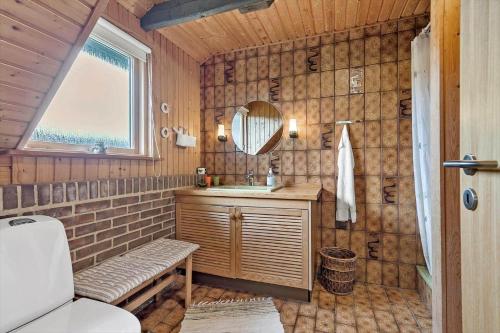 a bathroom with a sink and a mirror at 112-Ringkobing-Sletten-12 in Søndervig