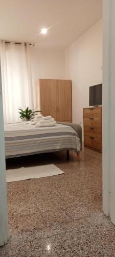 a bedroom with a large bed and a dresser at Cinghiale Bianco in Cagliari
