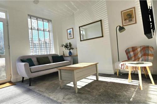 a living room with a couch and a table at Contractor Friendly - Long Stay Discount in Ipswich