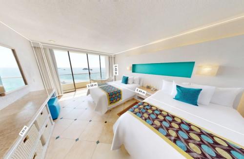 a hotel room with two beds and a view of the ocean at Sunscape Dorado Pacifico Ixtapa Resort & Spa- All Inclusive in Ixtapa