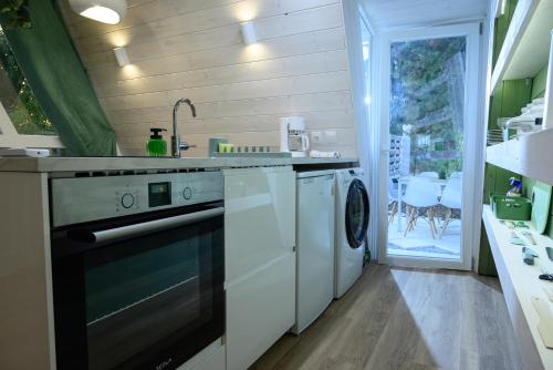 a kitchen with a washer and dryer in it at White DIAMOND in Chalkidiki in Vergia