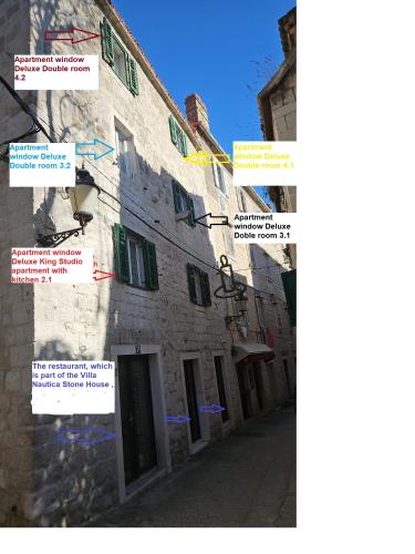a group of signs on the side of a building at Villa Nautica Stone House in Split