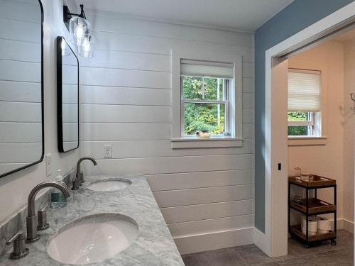 a bathroom with two sinks and a window at Long Lake-Lake Front - in Bridgton