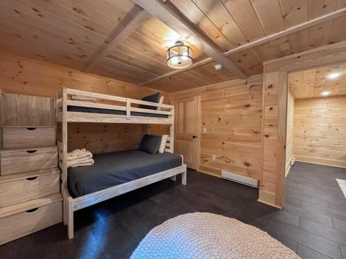 a bedroom with two bunk beds in a log cabin at Long Lake-Lake Front - in Bridgton