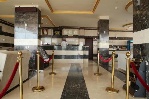 a lobby with red ribbon barriers and a counter at Beauty Rayan 2 in Jazan