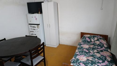 a small room with a table and a refrigerator at Tu alojamiento in Tacuarembó