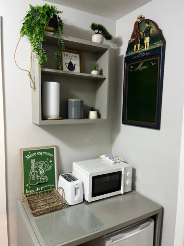 a counter with a microwave and a chalkboard at Shore Street Apartments in Inverness