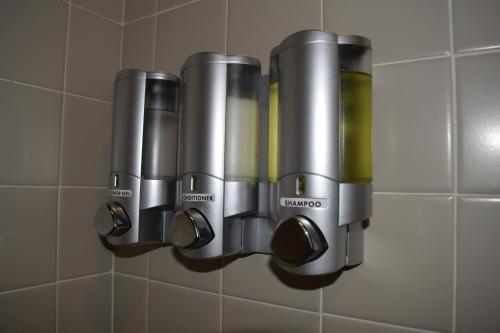 a group of three drinking cups on a wall at The Urban in San Francisco