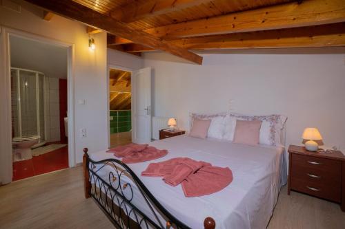 a bedroom with a bed with two towels on it at Alex house in Kouramaditika