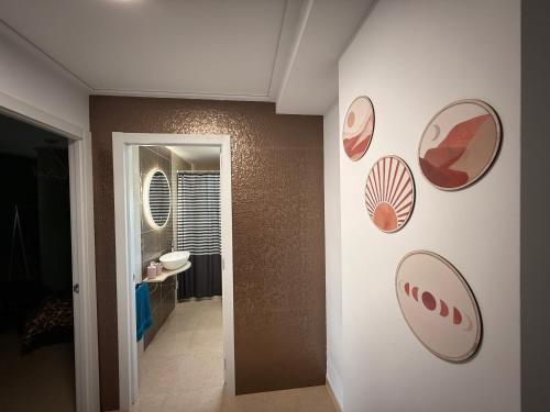 a hallway with several plates on the wall at Duplex Deluxe in Torreblanca