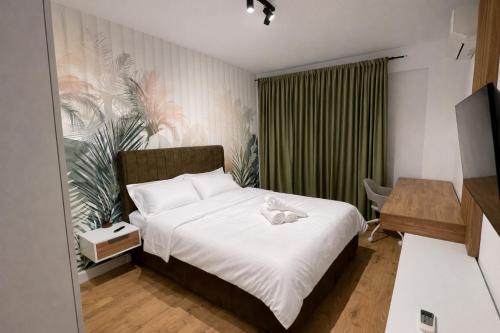 a bedroom with a bed with a stuffed animal on it at Apartament Modern Urban Space - FREE Parking in Voluntari