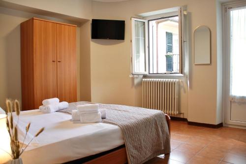 a bedroom with a bed with towels on it at Hotel Luina in Stresa