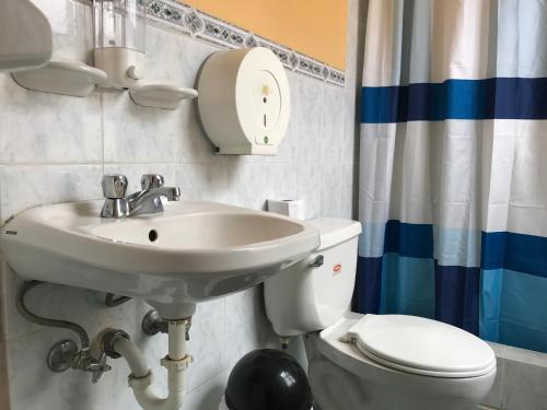 a bathroom with a sink and a toilet at The Yellow House in Quito