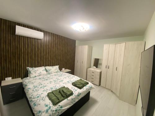a small bedroom with a bed and a dresser at Яни Хоум in Gabrovo