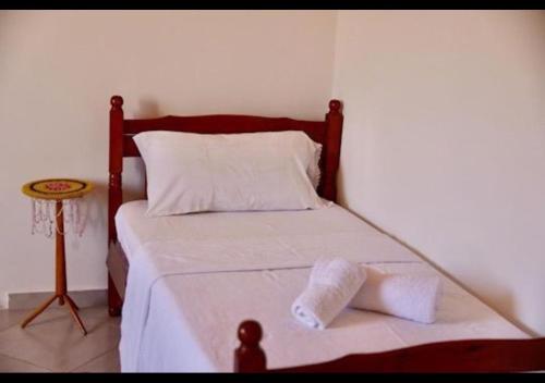 a bed in a room with a pillow on it at Shpija E AMEL (Sweet Guest House) in Ferr-Shkopet