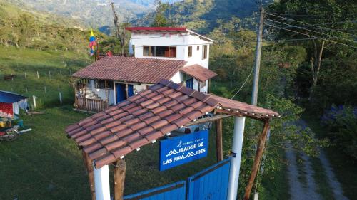 a small house with a sign in front of it at Mirador De Las Pirámides in Zetaquira