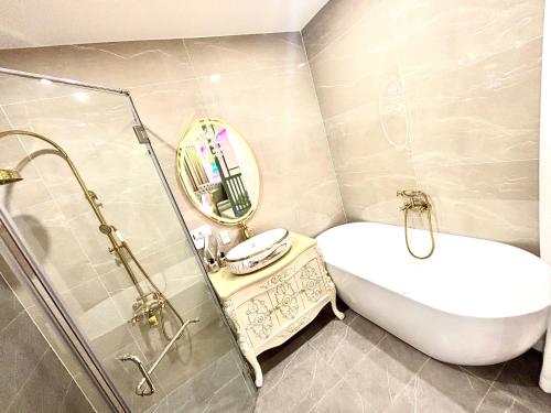 a bathroom with a sink and a mirror at New Pearl Hotel HCM in Ho Chi Minh City
