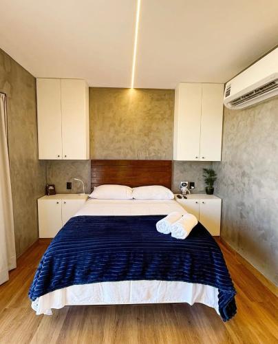 a bedroom with a bed with two towels on it at Canto Flix in Brasília