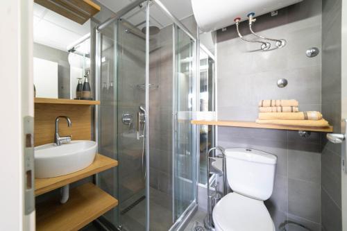 a bathroom with a shower and a toilet and a sink at Villa White Lake - Ohrid Center Lakeside Accommodation in Ohrid
