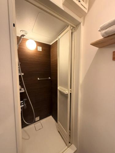 a bathroom with a shower with a glass door at Q FOX BLACK DIAMOND HOTEL in Kutchan