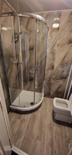 a bathroom with a shower and a toilet at The Grafton Rooms in Northampton