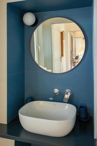 a bathroom with a white tub and a mirror at Luna Nova in Meina