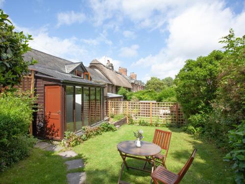 a patio with a table and chairs in a yard at Mill Bank No 8 - Uk33902 in Ashsprington