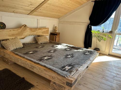 a bedroom with a wooden bed with a wooden floor at Хатка у долині in Kosiv