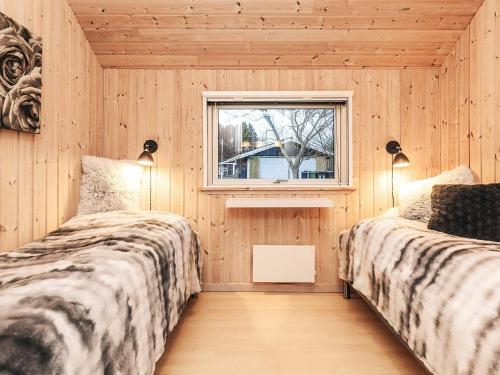 two beds in a room with a window at Luxury Retreat by Kramnitze in Rødby