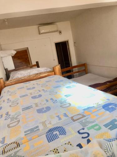 a bedroom with a bed and two beds in it at Hostel Base La Rioja in La Rioja