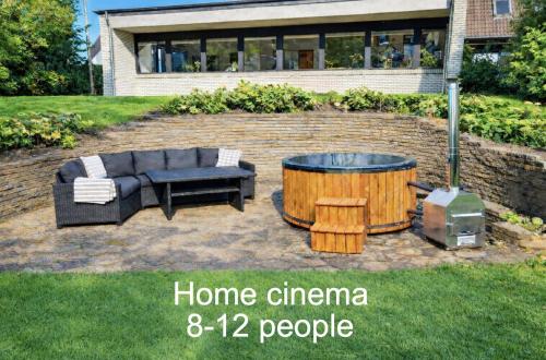 a backyard with a hot tub and a couch and a table at Family friendly - Give apartment in Billund