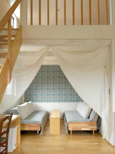 a room with two beds in a loft at yucurum in Itoman