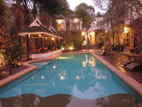 a large swimming pool in a yard at night at Keereeta Resort in Ko Chang
