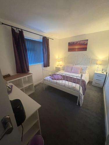 a bedroom with a white bed and a window at Abbey Meadows View ABB in Redditch