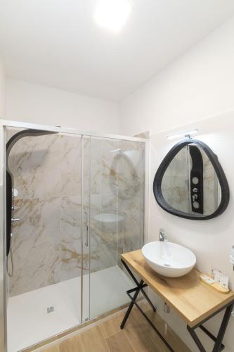 a bathroom with a shower with a sink and a mirror at Ne Ta B&B Ravenna in Ravenna