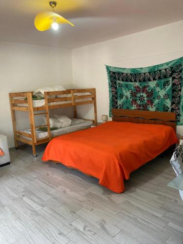 a bedroom with a bed with an orange blanket at Villa Marine Plus in Fontane Bianche