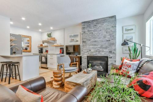 a living room with a couch and a fireplace at A Rustic Modern Mountain Condo - 2 bed, 2-Level in Canmore