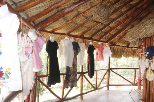 a room filled with clothes hanging from a ceiling at Cabañas "El jardín del Edén" in Valladolid