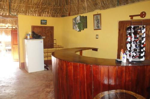 a bar in a room with a bunch of wine bottles at Cabañas "El jardín del Edén" in Valladolid