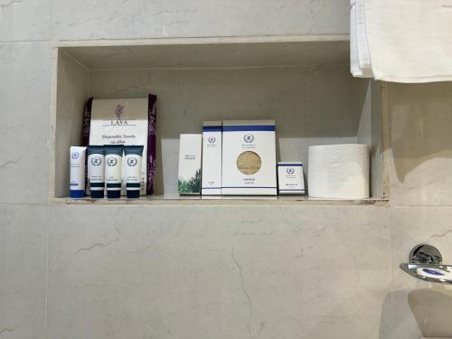 a shelf in a bathroom with boxes on it at متسع للشقق المخدومة - اقتصادي in Hail